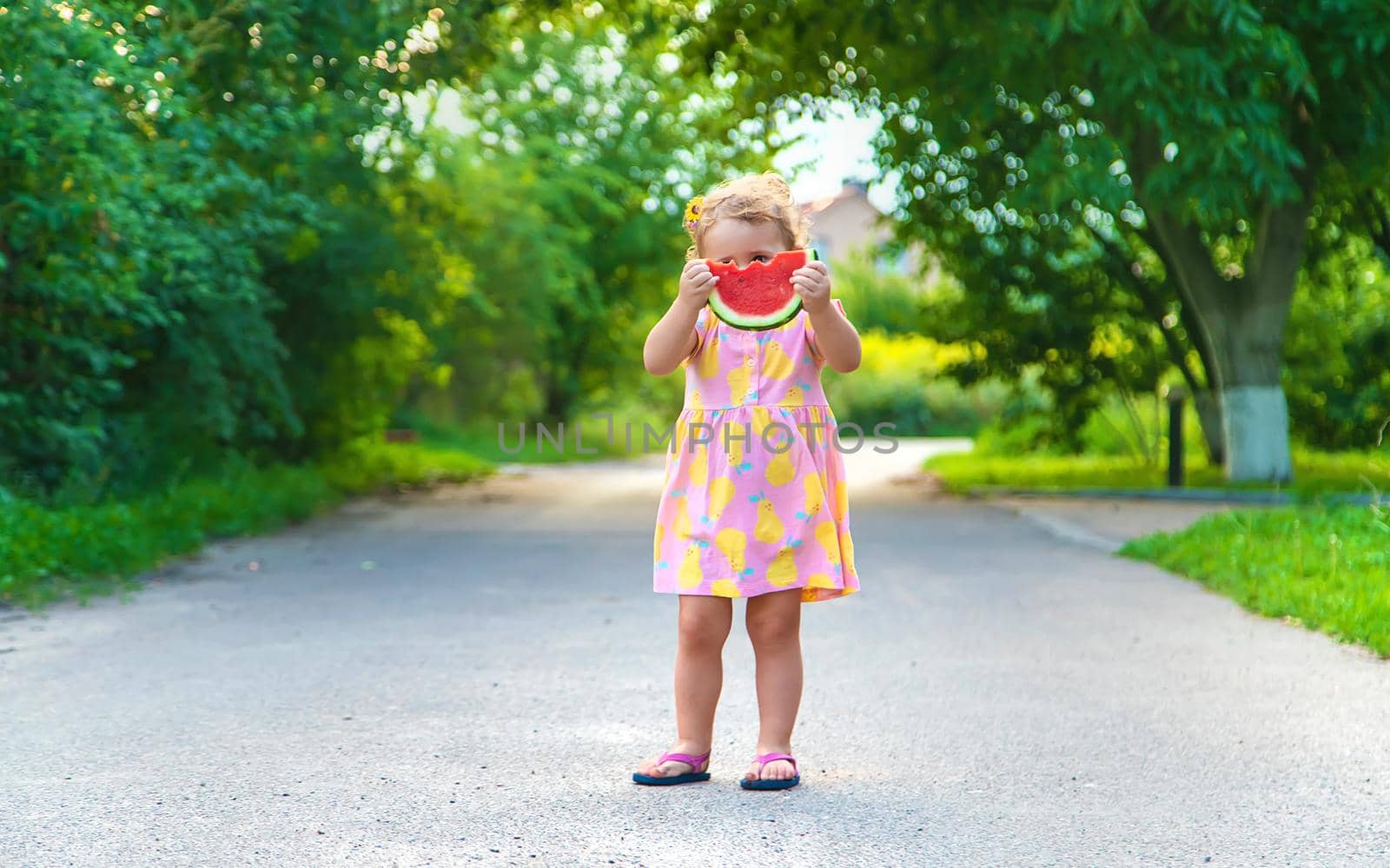 Child girl eats watermelon in summer. Selective focus. food.