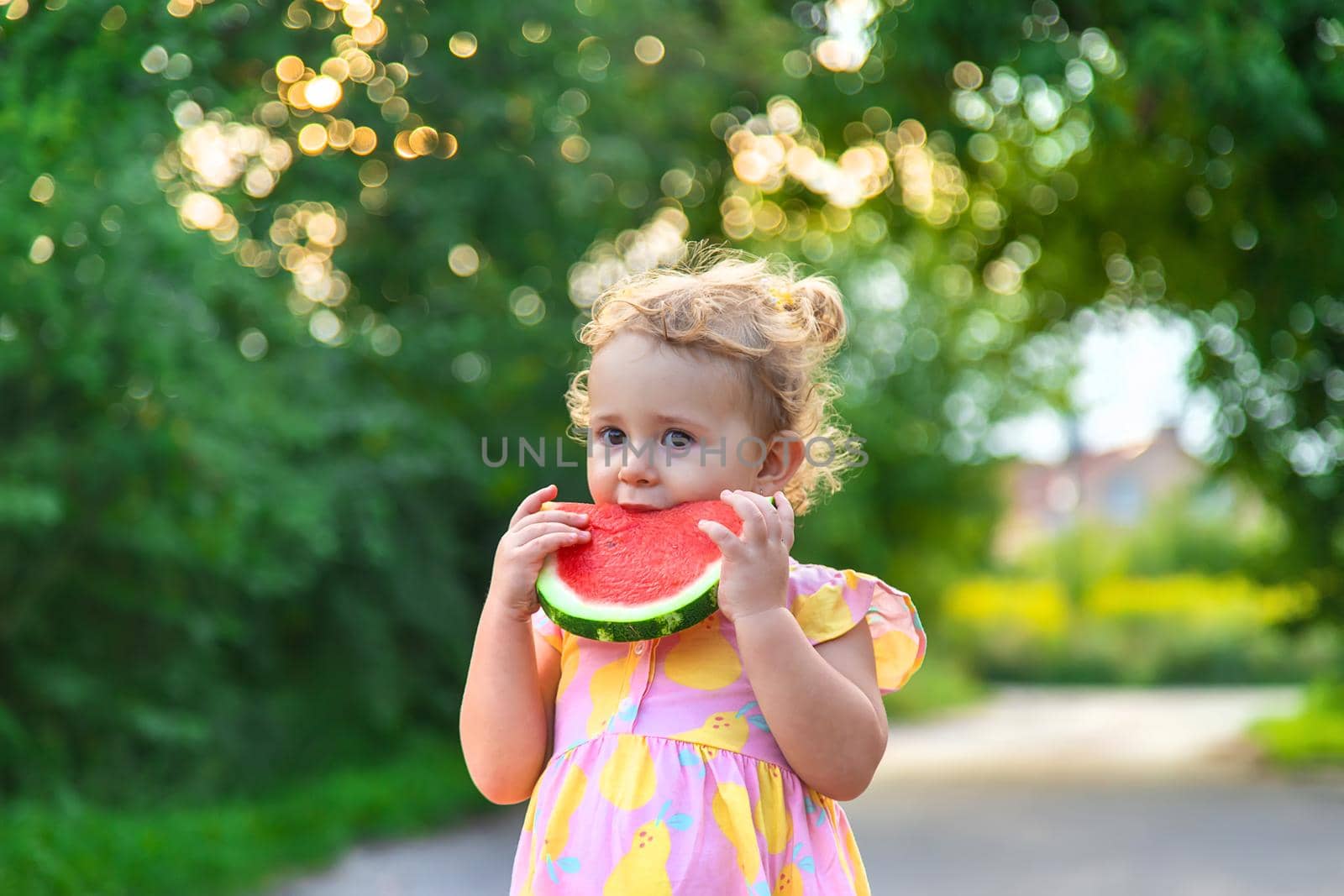 Child girl eats watermelon in summer. Selective focus. food.