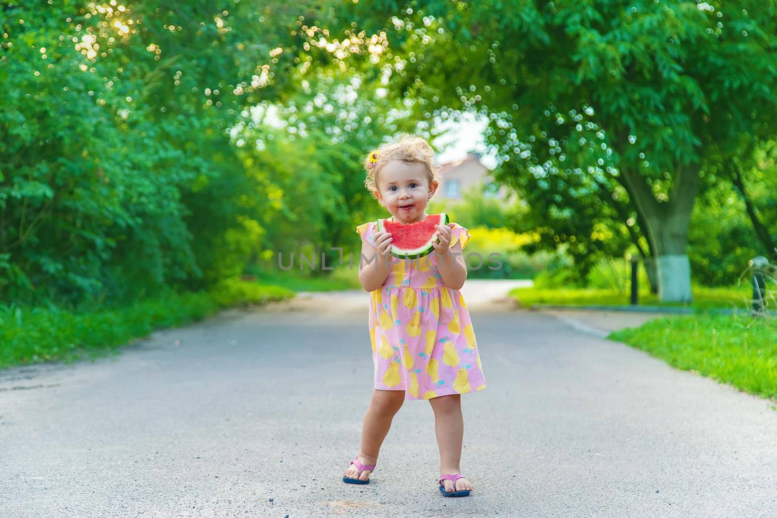 Child girl eats watermelon in summer. Selective focus. food.