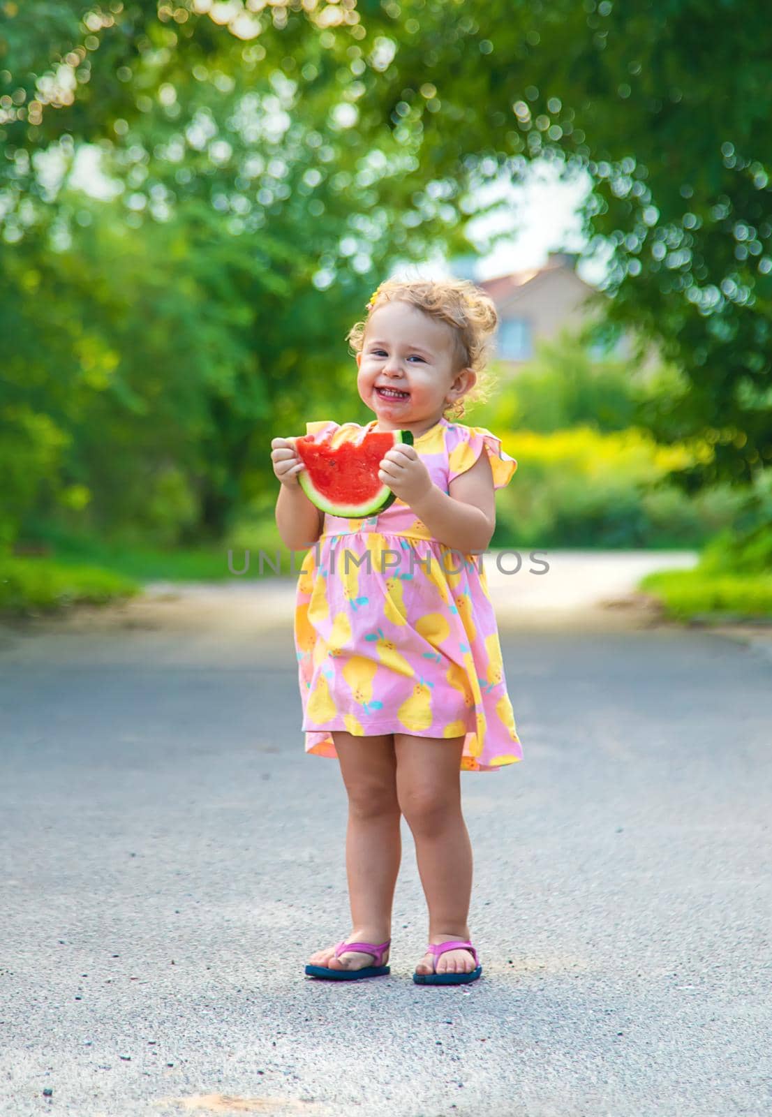 Child girl eats watermelon in summer. Selective focus. food.
