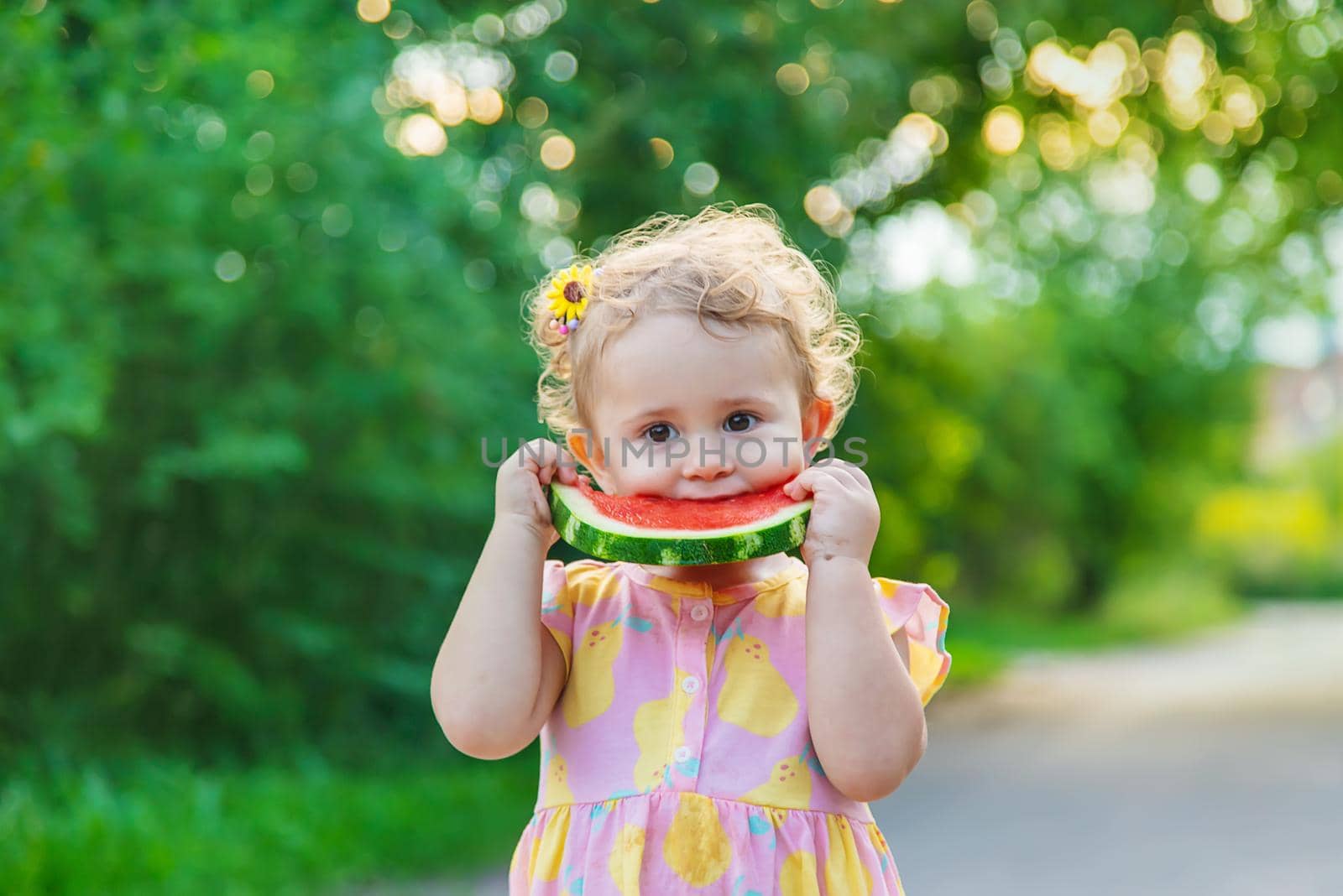 Child girl eats watermelon in summer. Selective focus. food.