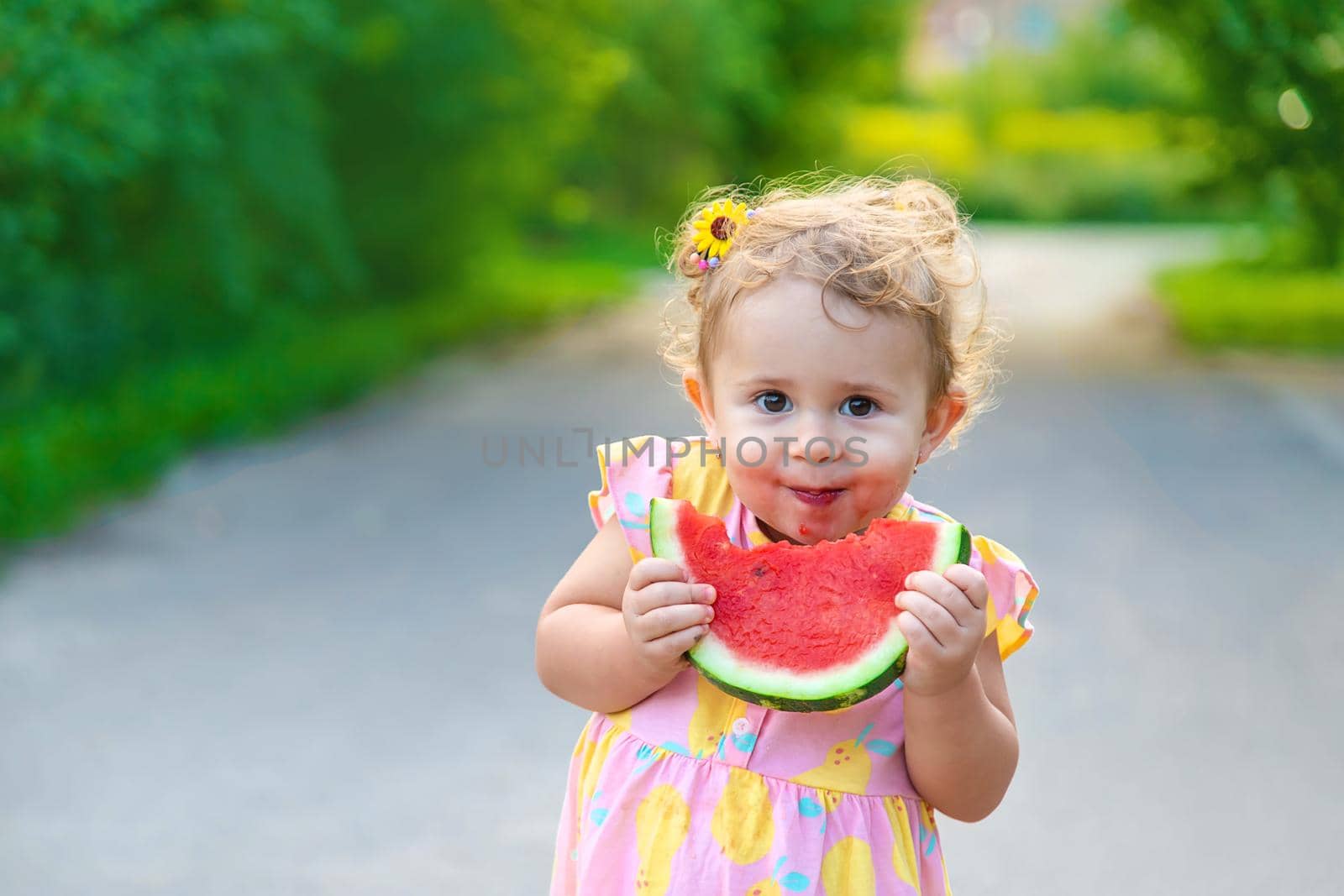 Child girl eats watermelon in summer. Selective focus. food.