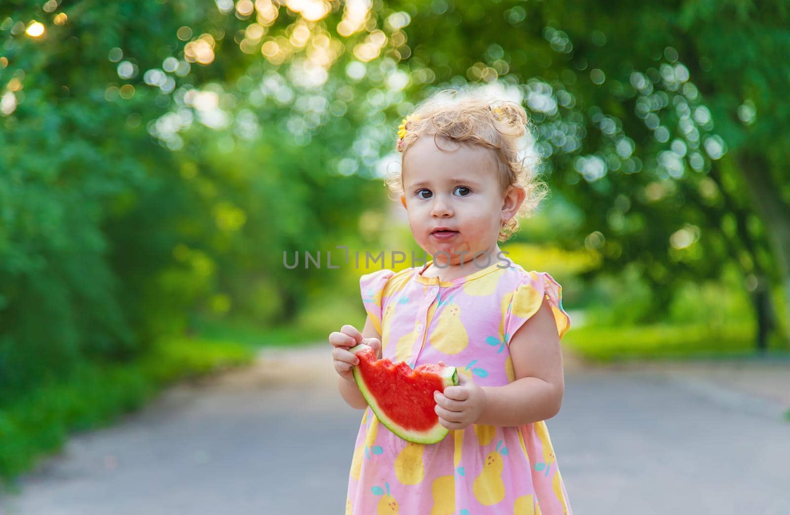 Child girl eats watermelon in summer. Selective focus. food.