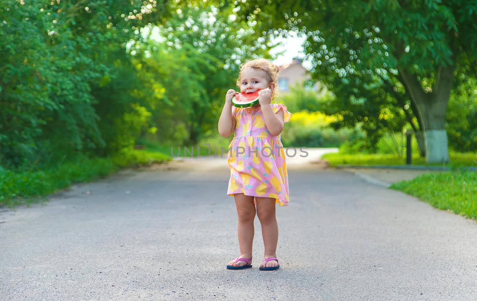 Child girl eats watermelon in summer. Selective focus. food.