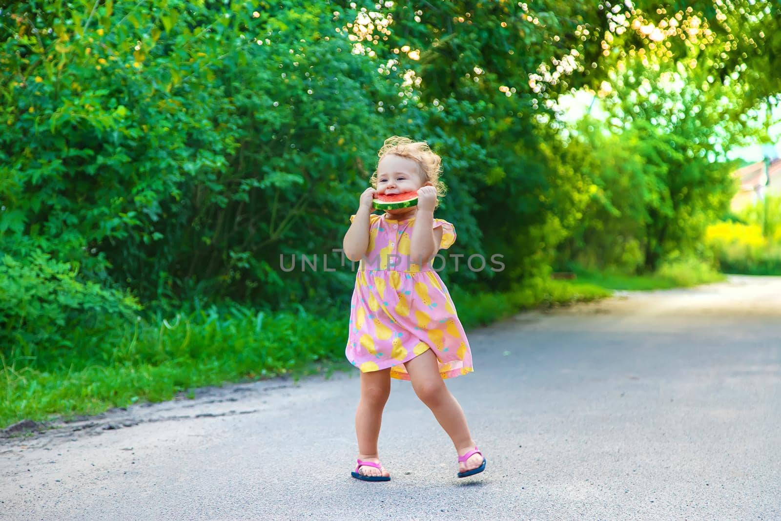 Child girl eats watermelon in summer. Selective focus. food.