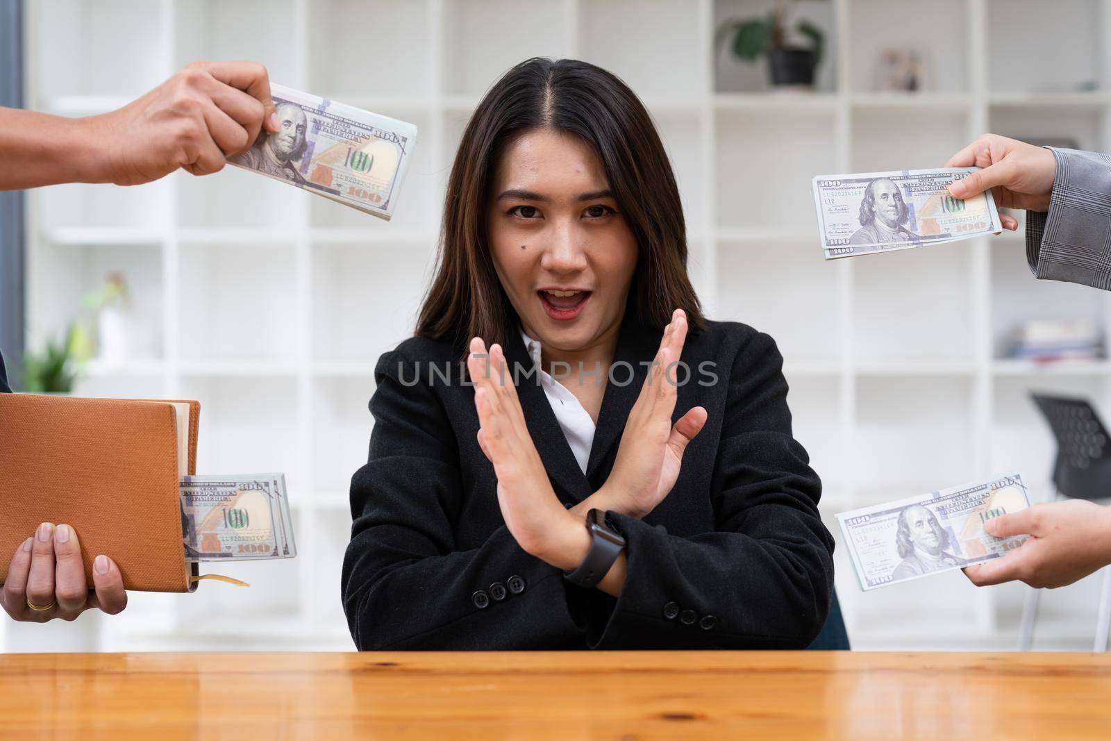 Asian woman refusing money in the envelope to agreement contract, Bribe and corruption concept.