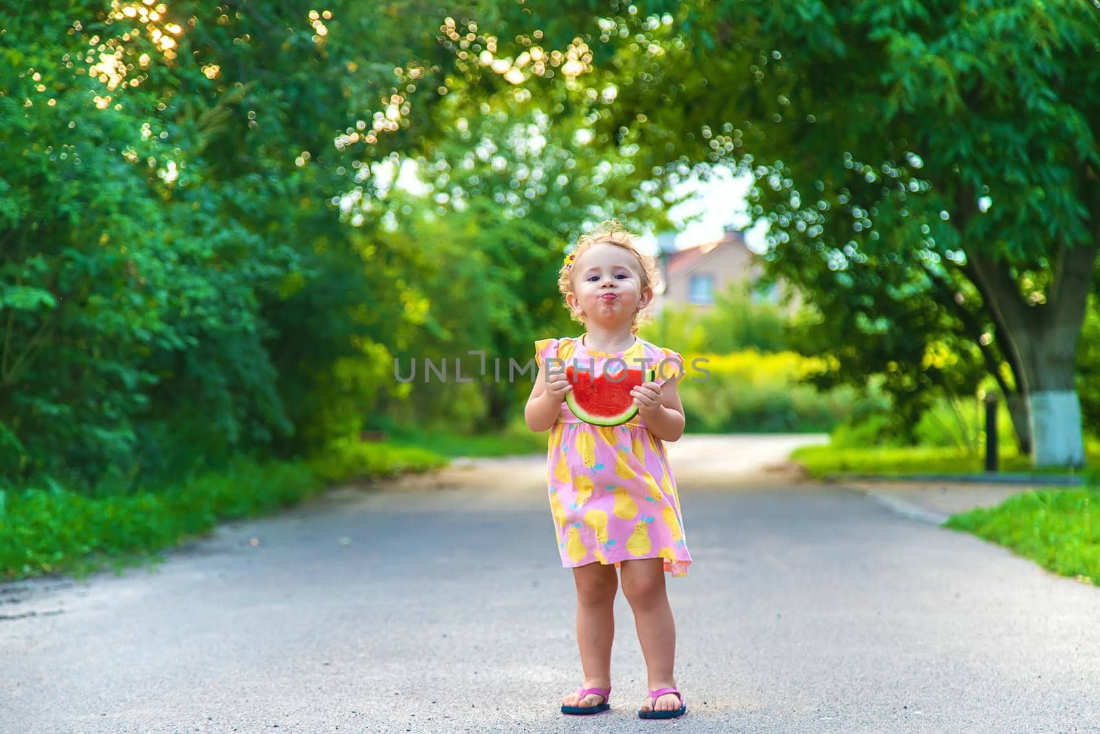 Child girl eats watermelon in summer. Selective focus. food.