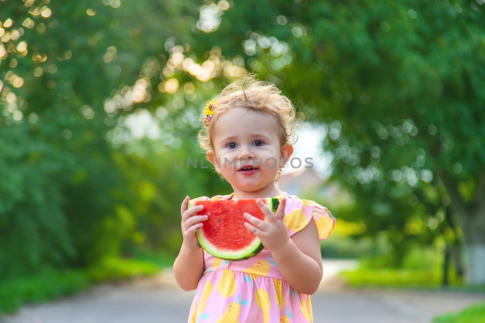 Child girl eats watermelon in summer. Selective focus. food.