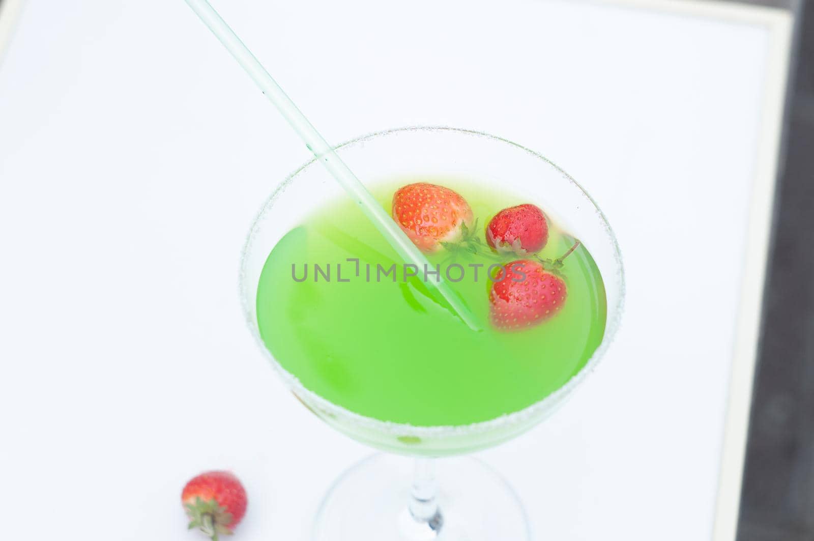 Colorful bright green cocktail cactus with strawberries, delicious refreshing summer drink, tonic drinks. High quality photo