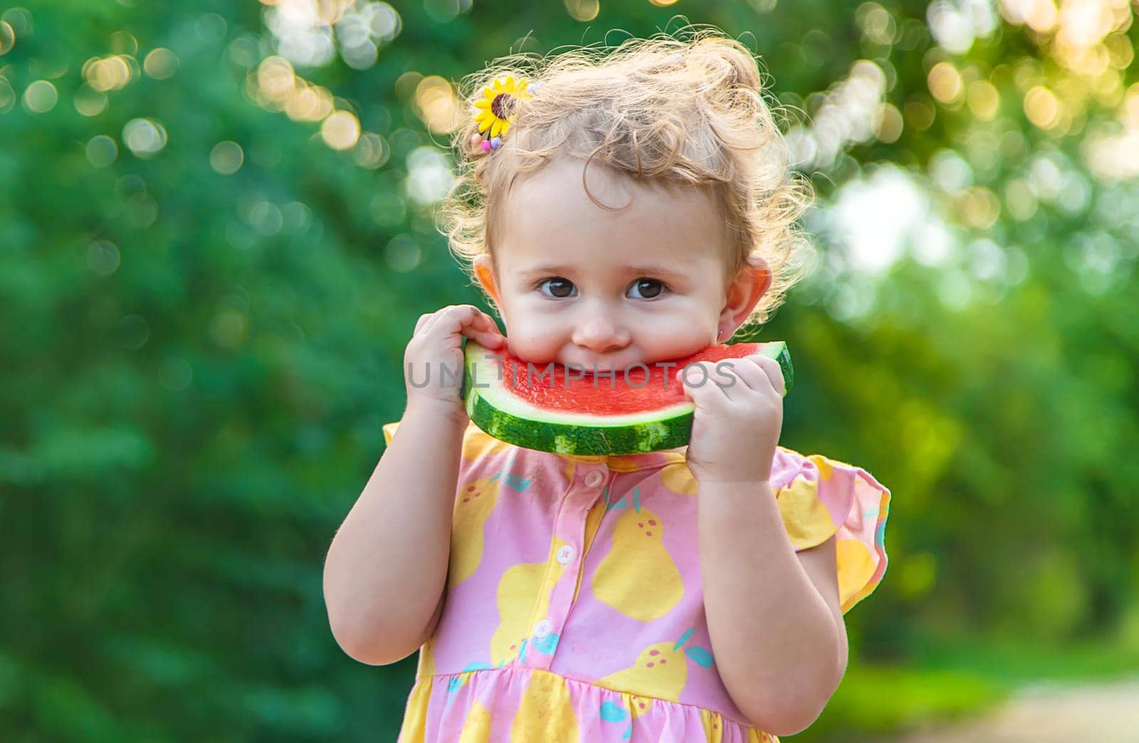 Child girl eats watermelon in summer. Selective focus. food.