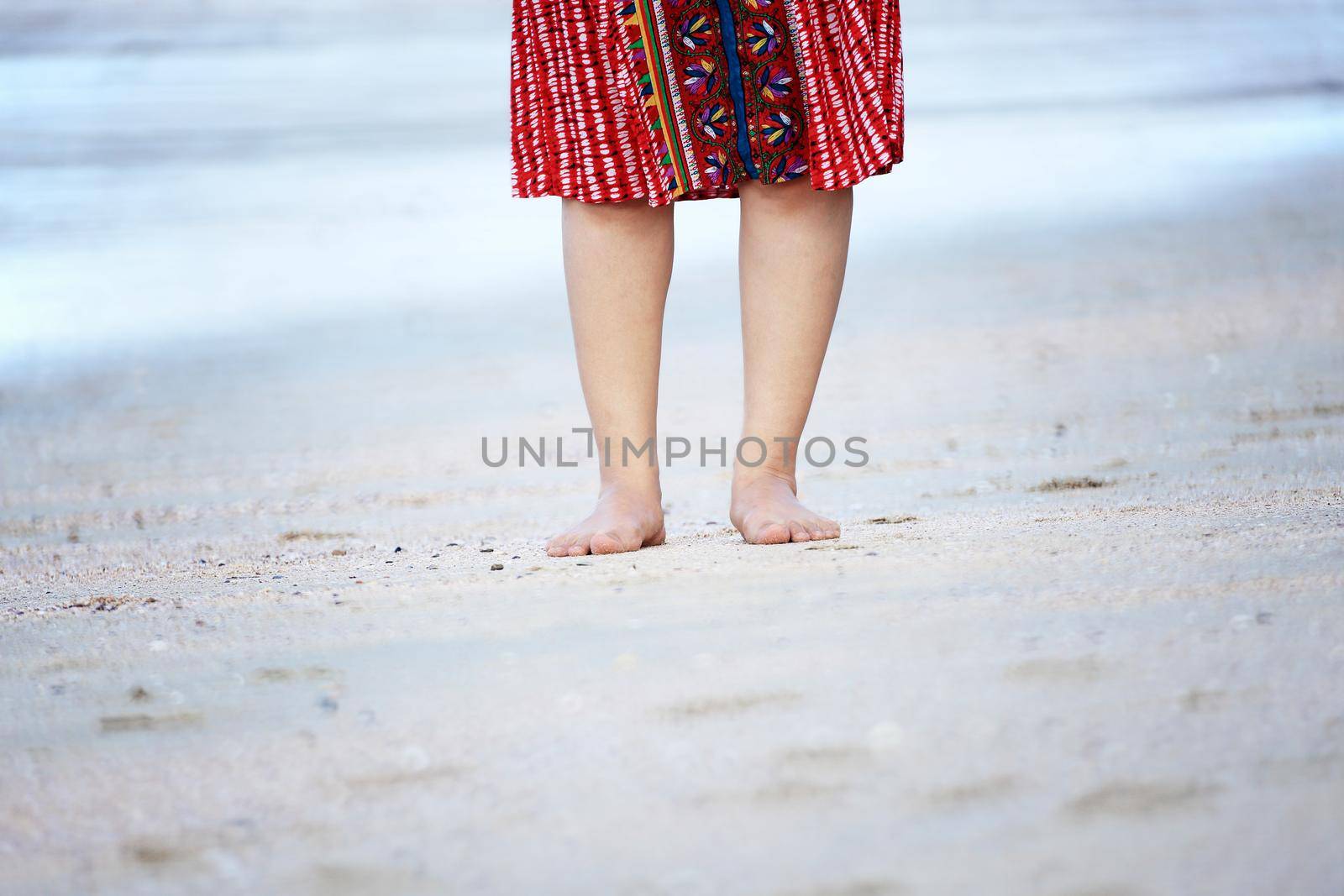 Bare feet of tourist woman enjoying travel vacation in Krabi, Thailand.