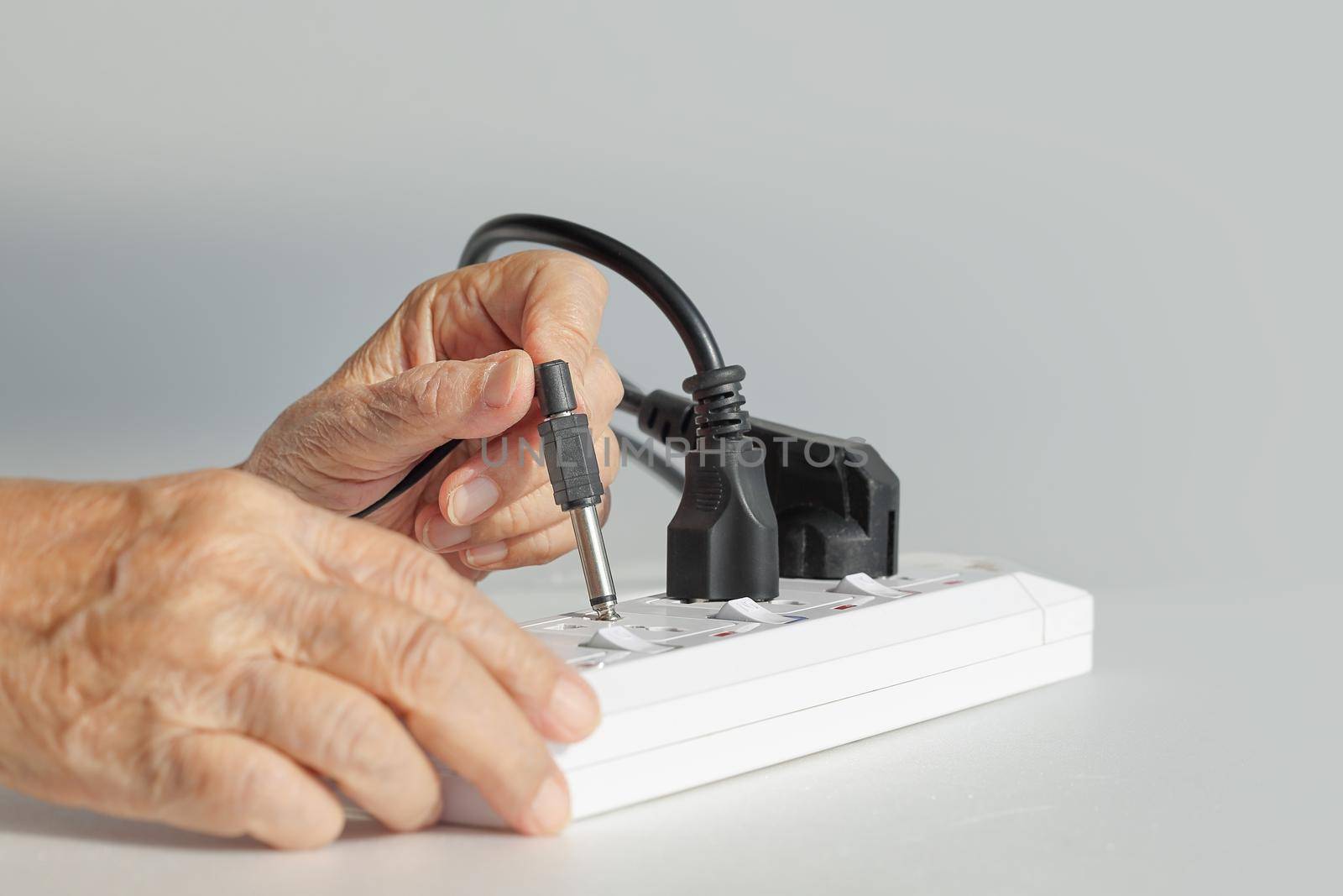 Elderly have a problem mistake plugging socket type to electrical outlet.