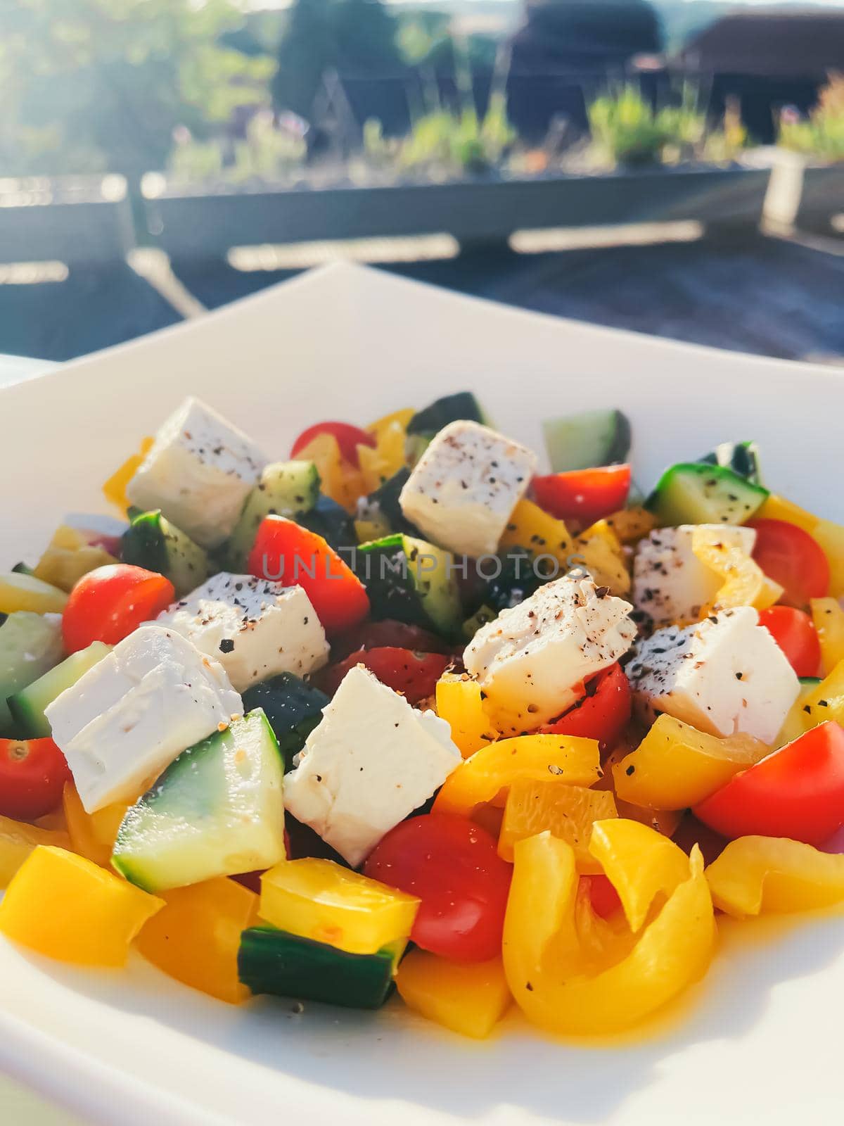 Fresh vegetable greek salad with cherry tomatoes, bell pepper, cucumber, feta cheese, olive oil and seasonal spices, healthy food diet and delicious meal recipe concept