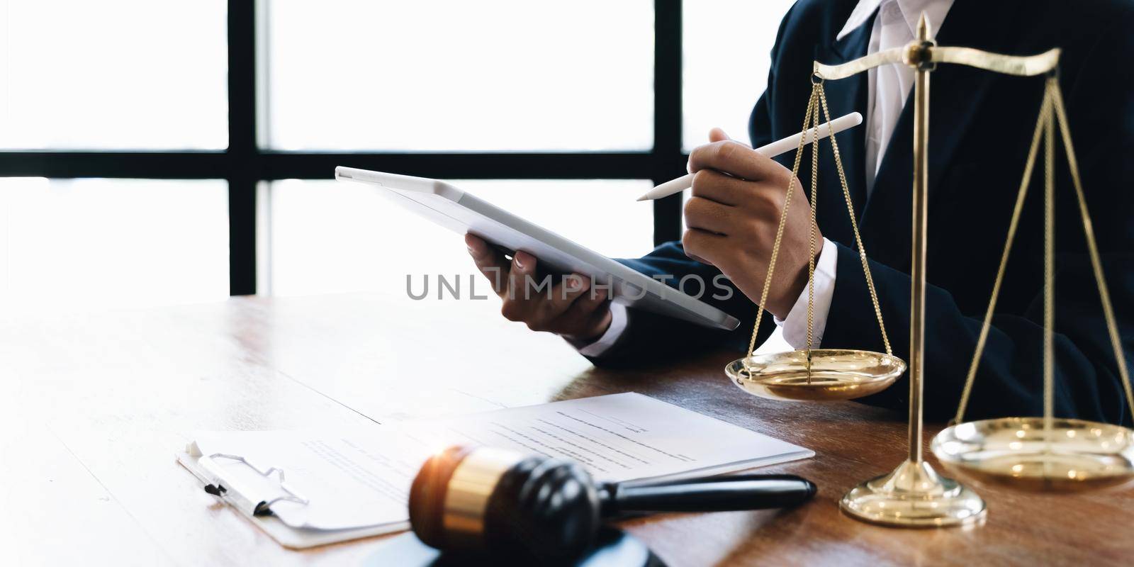 Law and Legal services concept, Good service cooperation, lawyer hands using tablet and working on wood table office. by wichayada