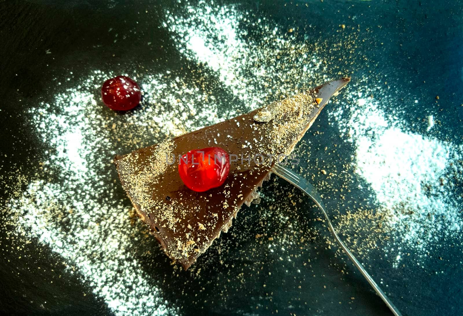 a gourmet piece of chocolate cake, torte on a decorated plate. Top view