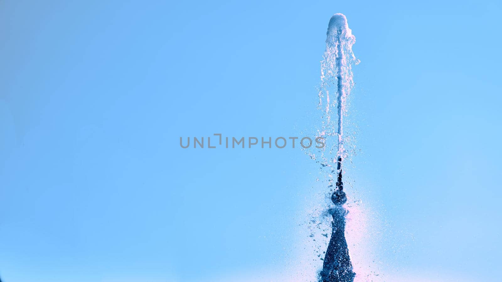 Fountain with shining clear liquid on a blue sky background by jovani68