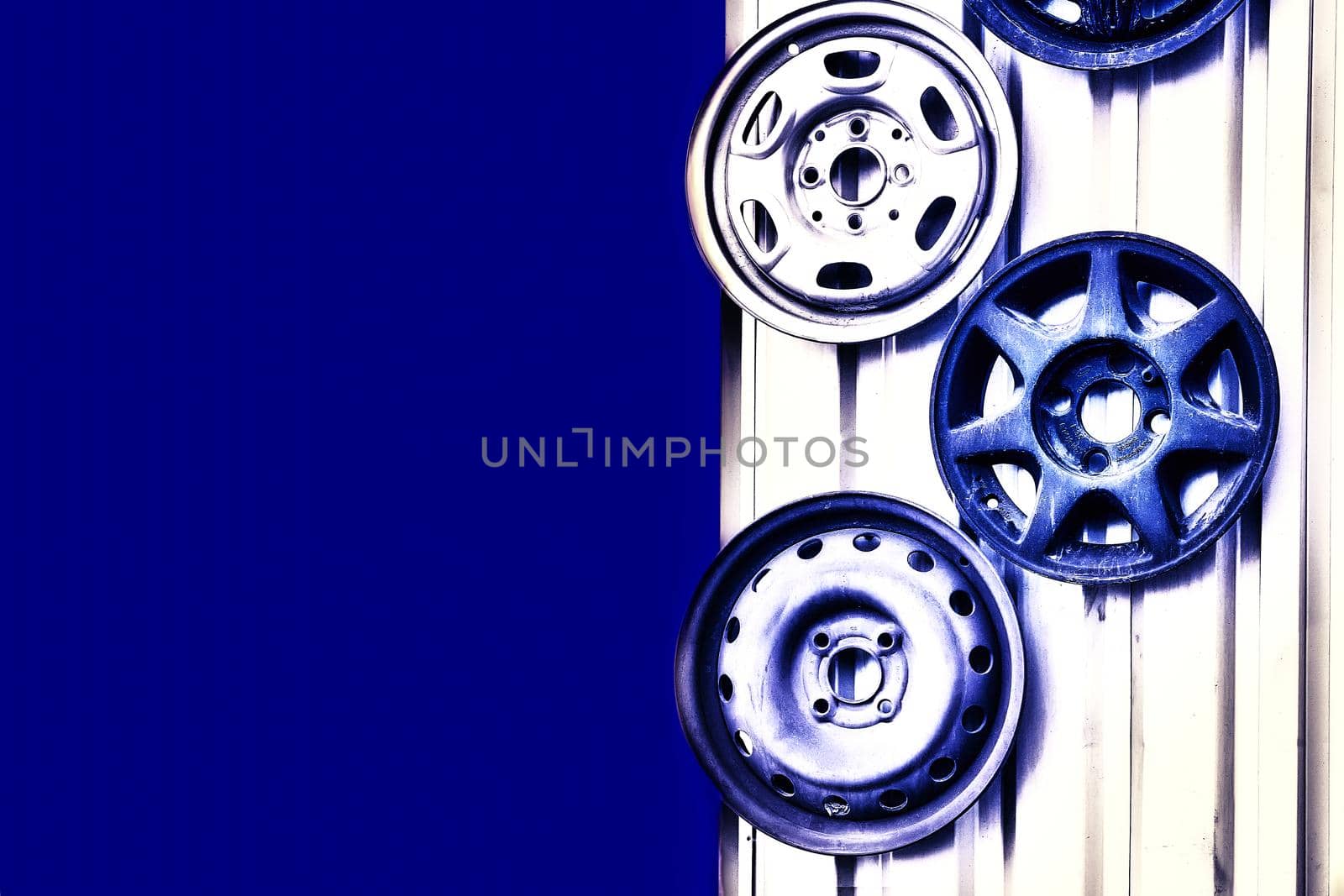 Three metal car rims hanging on the wall with space for text by jovani68