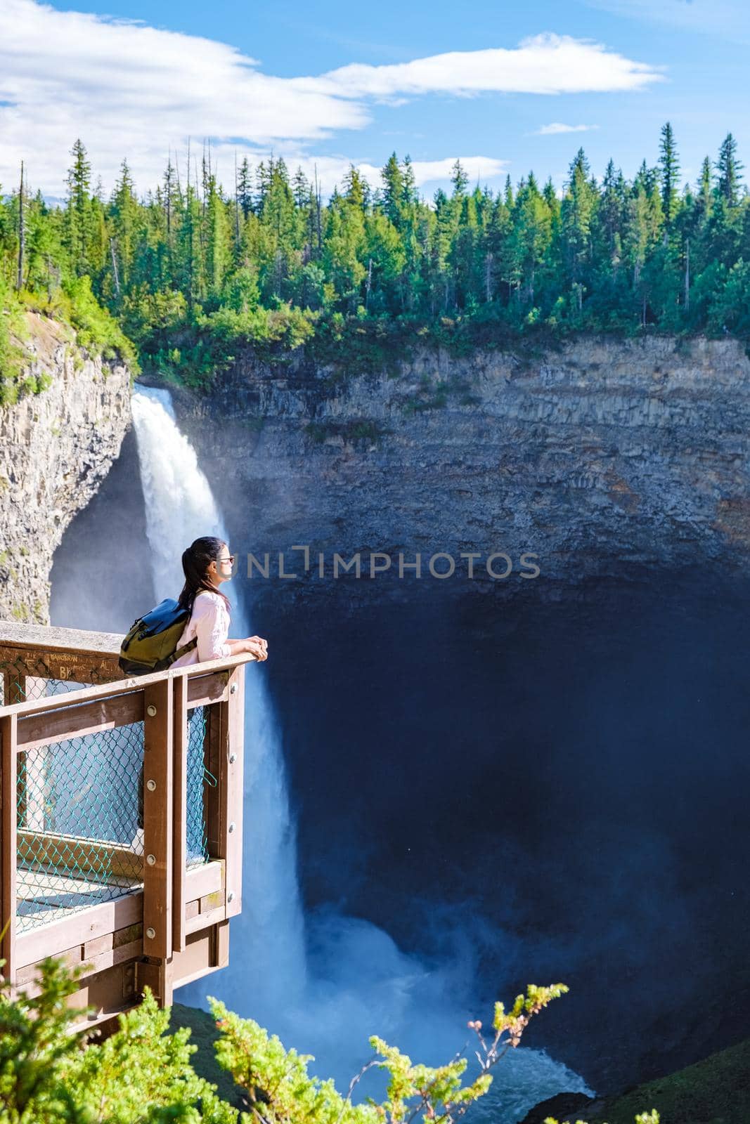 Helmcken Falls Wells Gray park British Colombia Canada, couple watching waterfall. a couple of men and women on a road trip in British Colombia in Canada standing by a waterfall in Wells Gray park BC
