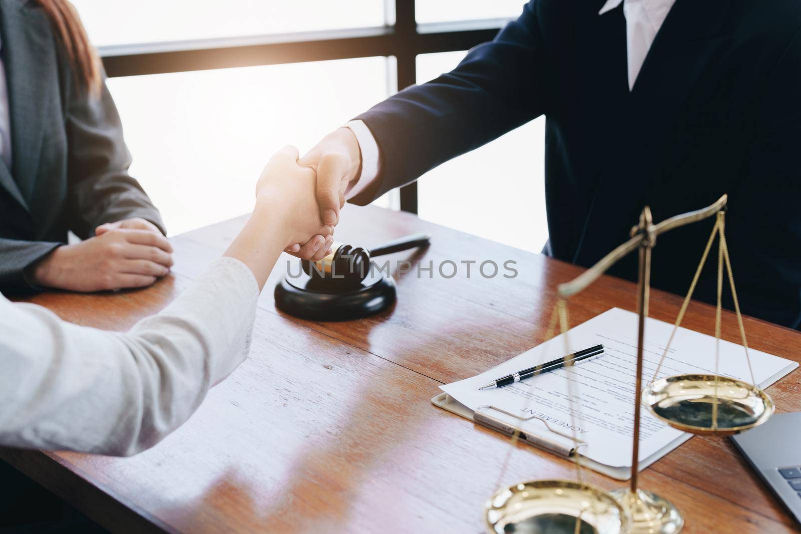 Lawyers shake hands to make Keating for clients.