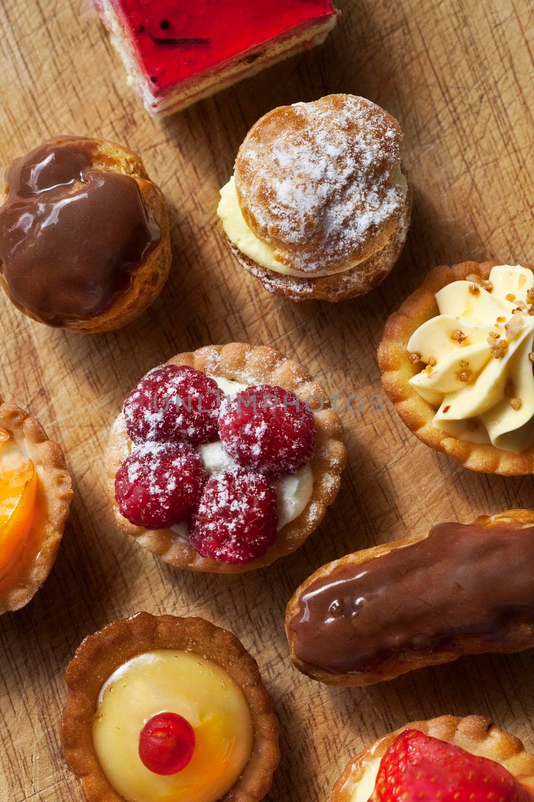 Close up of various French cakes on a wooden board
