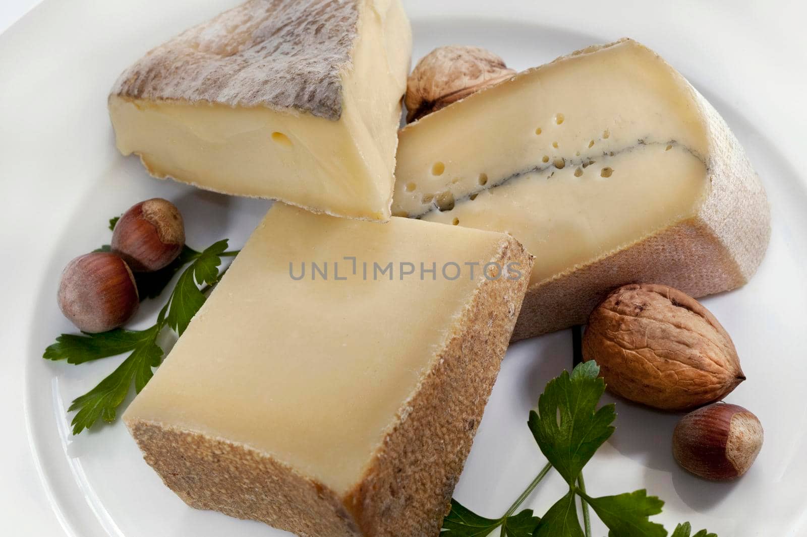 French cheese, parsley and nuts on a plate