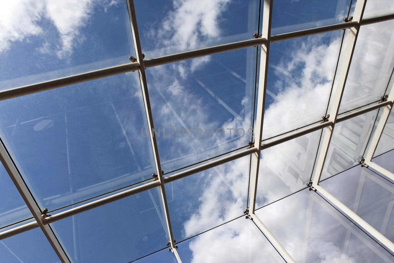 Close up of a glass roof and blue sky