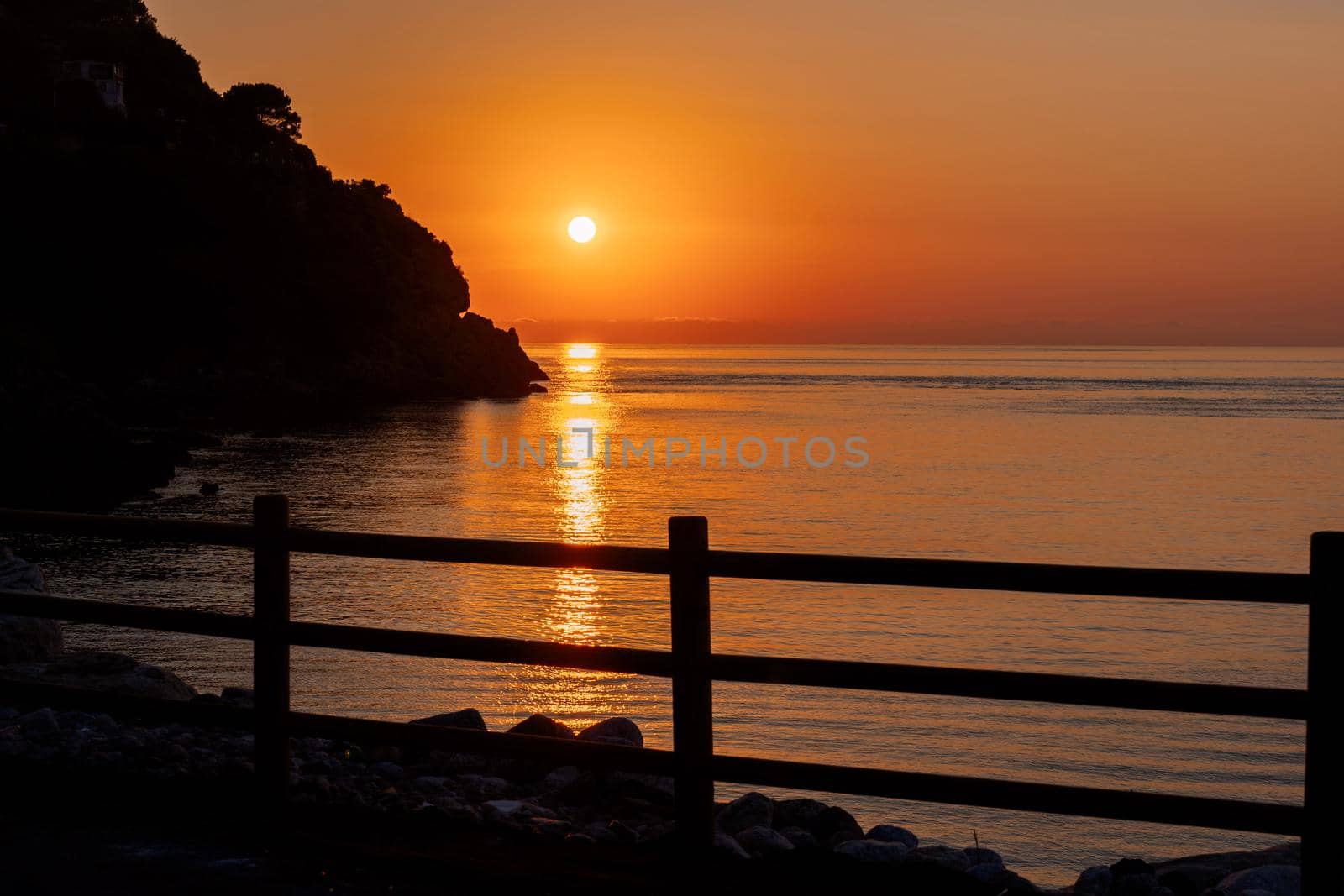 Beautiful view of orange sunset seascape with rocks in Italy. Tropical colourful sunrise landscape. Nature landscape. Tropical coast by photolime