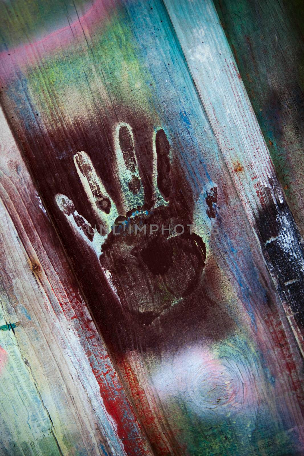 Dirty fingerprints on a wooden colorful wall