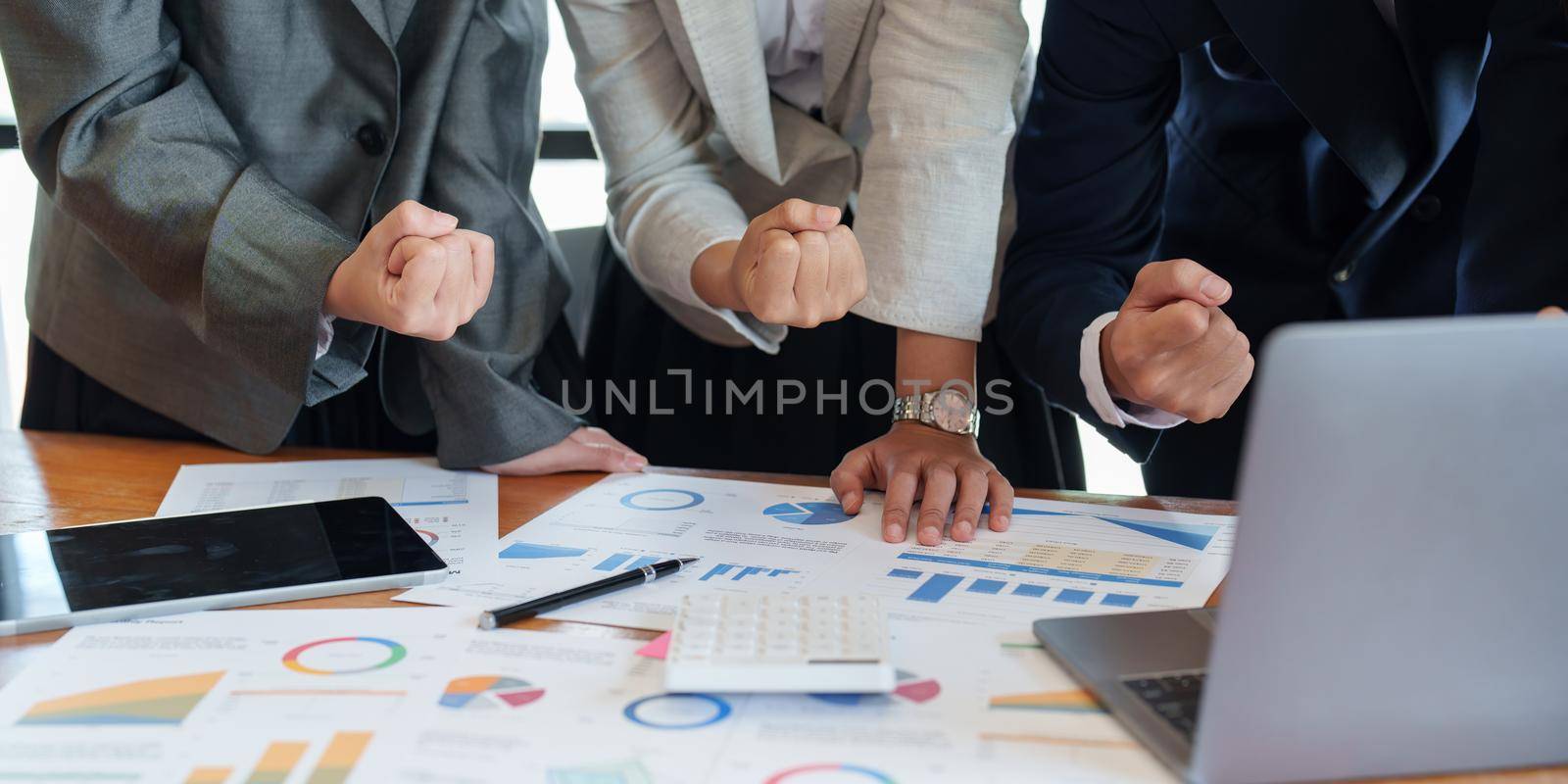 excited business team celebrate corporate victory together in office