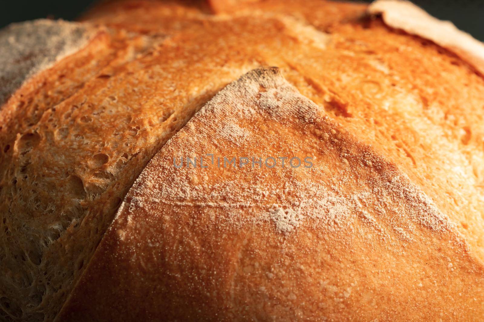 Fresh homemade round wheat crispy bread close-up, selective focus by galsand