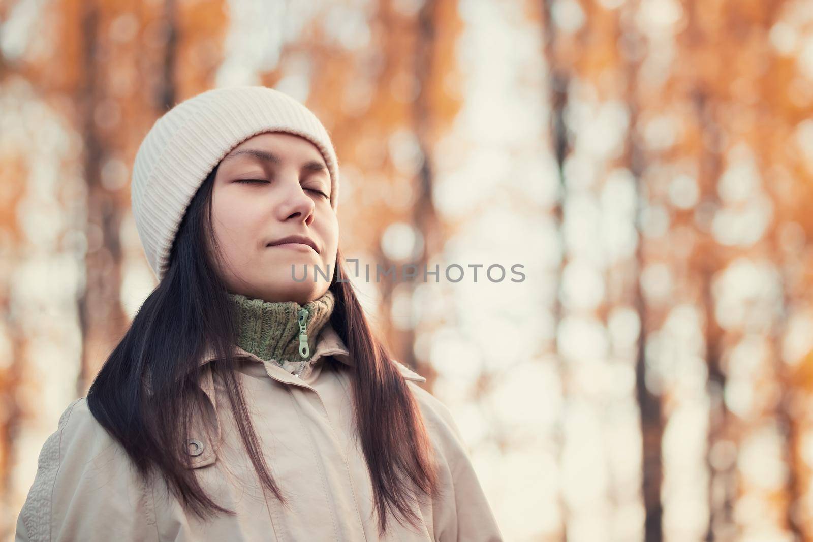 Girl enjoys fresh autumn air while walking in the park by galsand