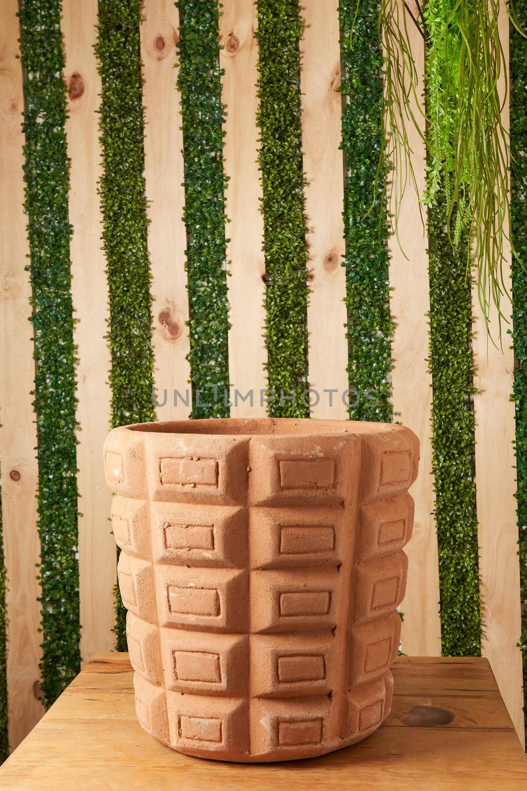 earthenware pot for plants on a wooden table with green plant background. catalog of plant pots. clay pot for plants.