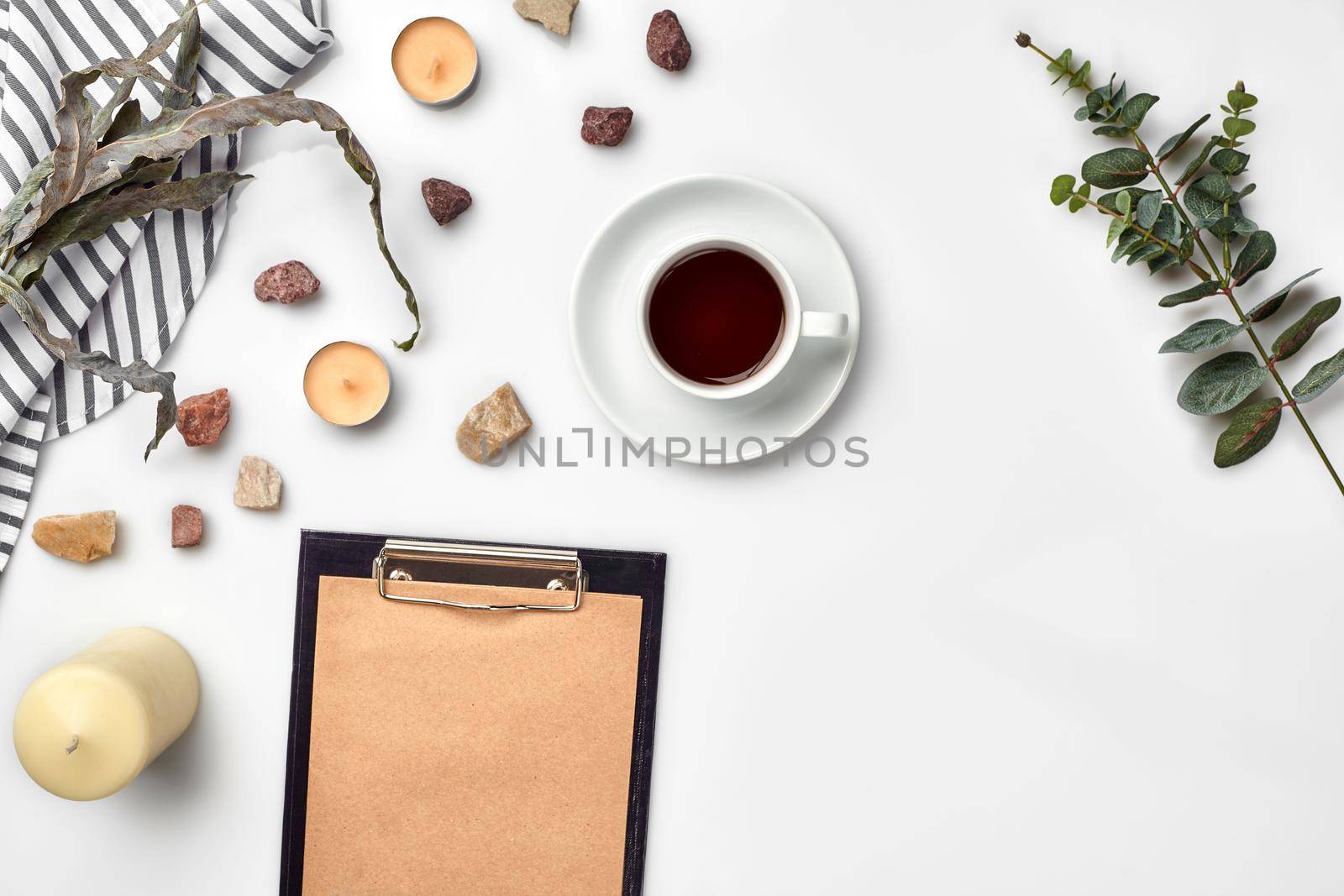 Blank opened notebook with cup of coffee on white table. Top view. Writing concept by nazarovsergey