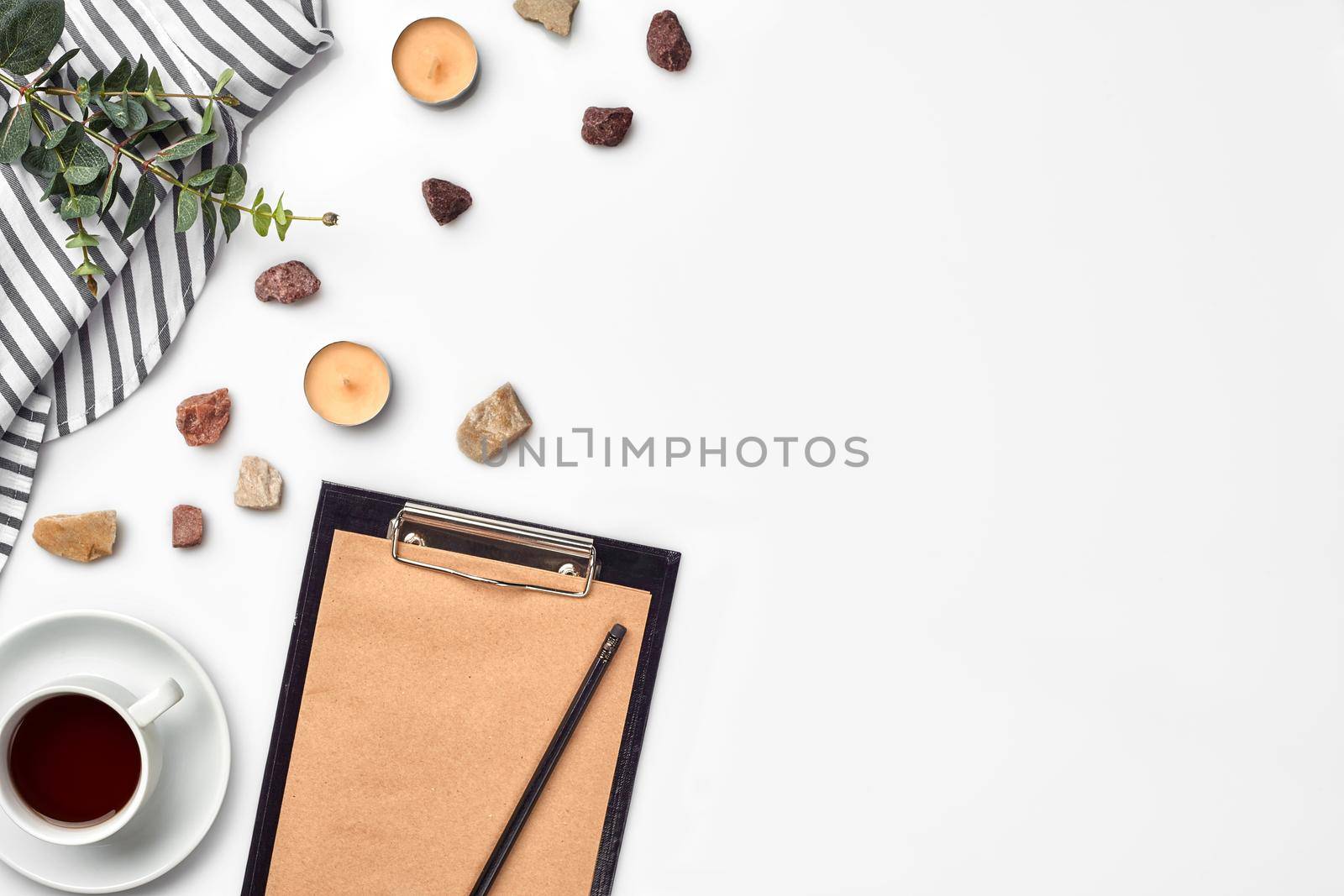 Blank opened notebook with cup of coffee on white table. Top view. Writing concept by nazarovsergey