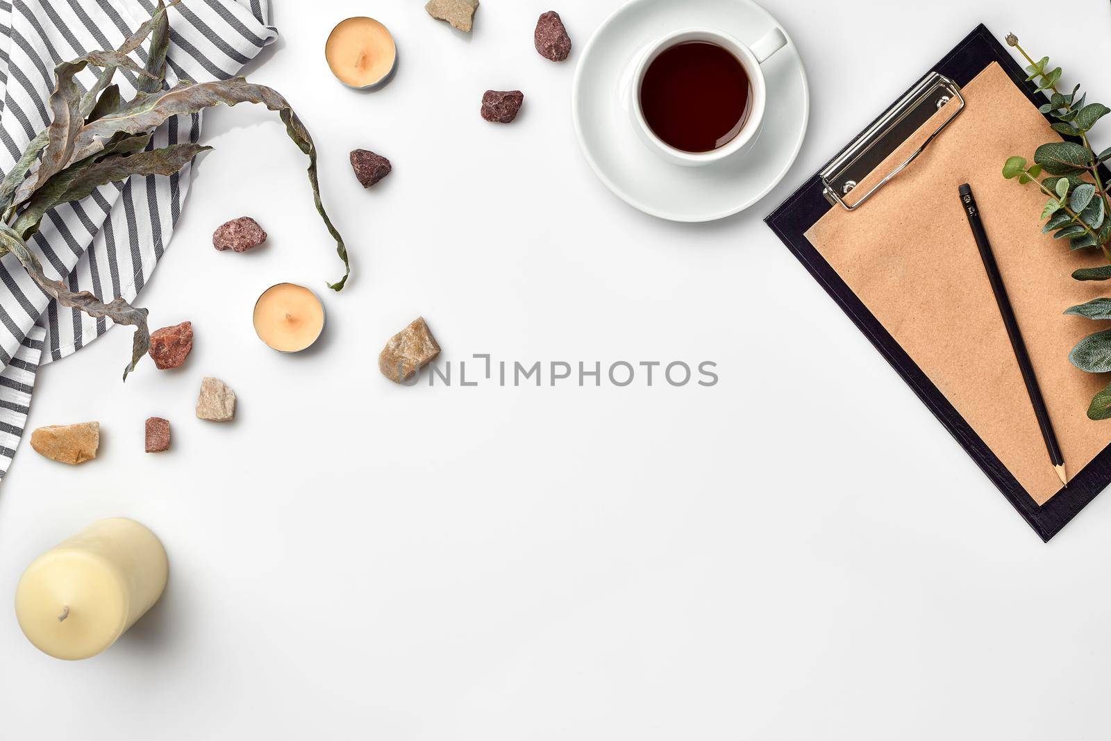 Blank opened notebook with cup of coffee on white table. Top view. Writing concept. Still life. Flat lay. Copy space