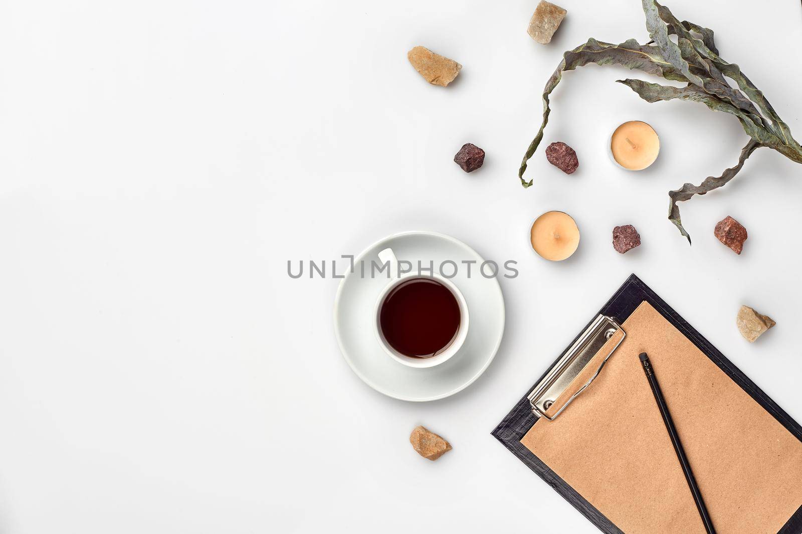 Opened diary with pen on the table near hot cup of black tea by nazarovsergey