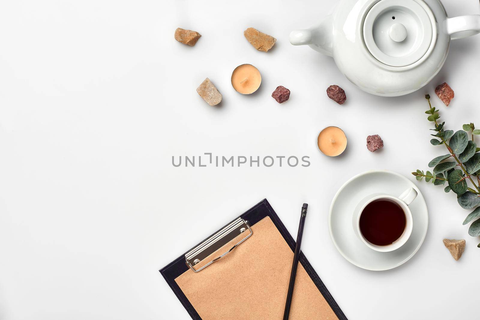 Opened diary with pen on the table near hot cup of black tea by nazarovsergey