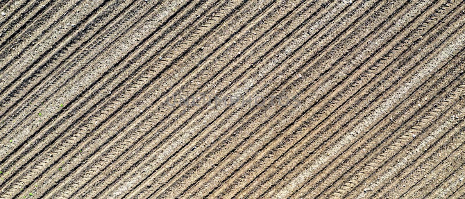 Banner of a clear plowed field with traces. View from the top. by EdVal