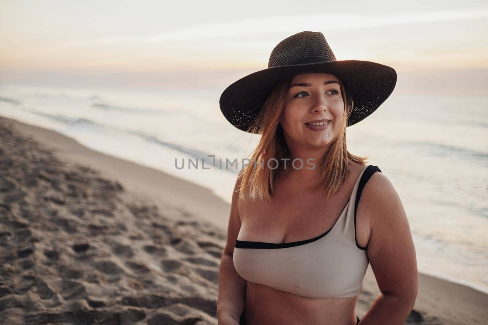 Close Up Portrait of Pretty Young Woman Looking Towards the Sea While Standing on Sandy Beach at Early Morning