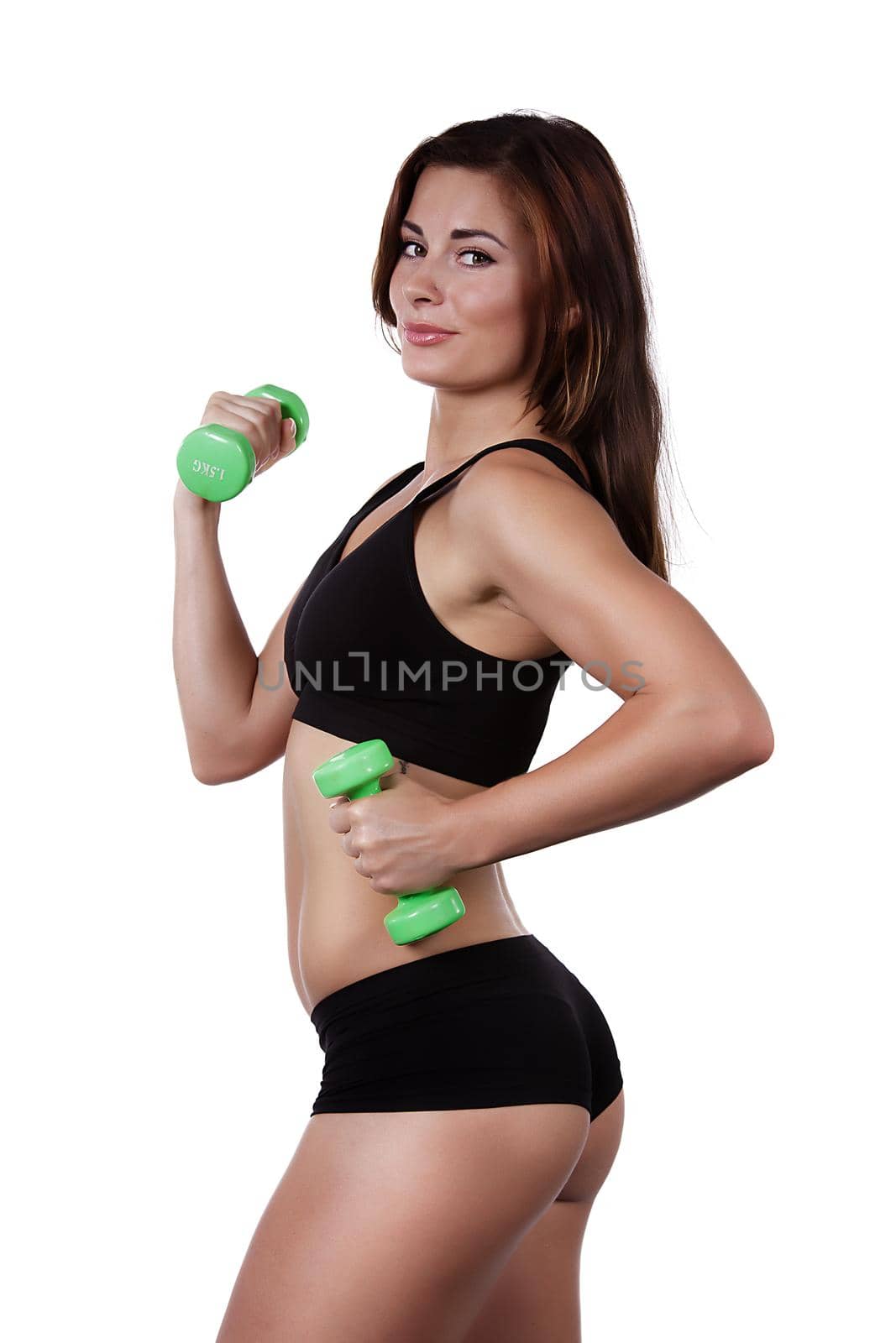 Fitness smiling girl with dumbbells on a white background in black clothes