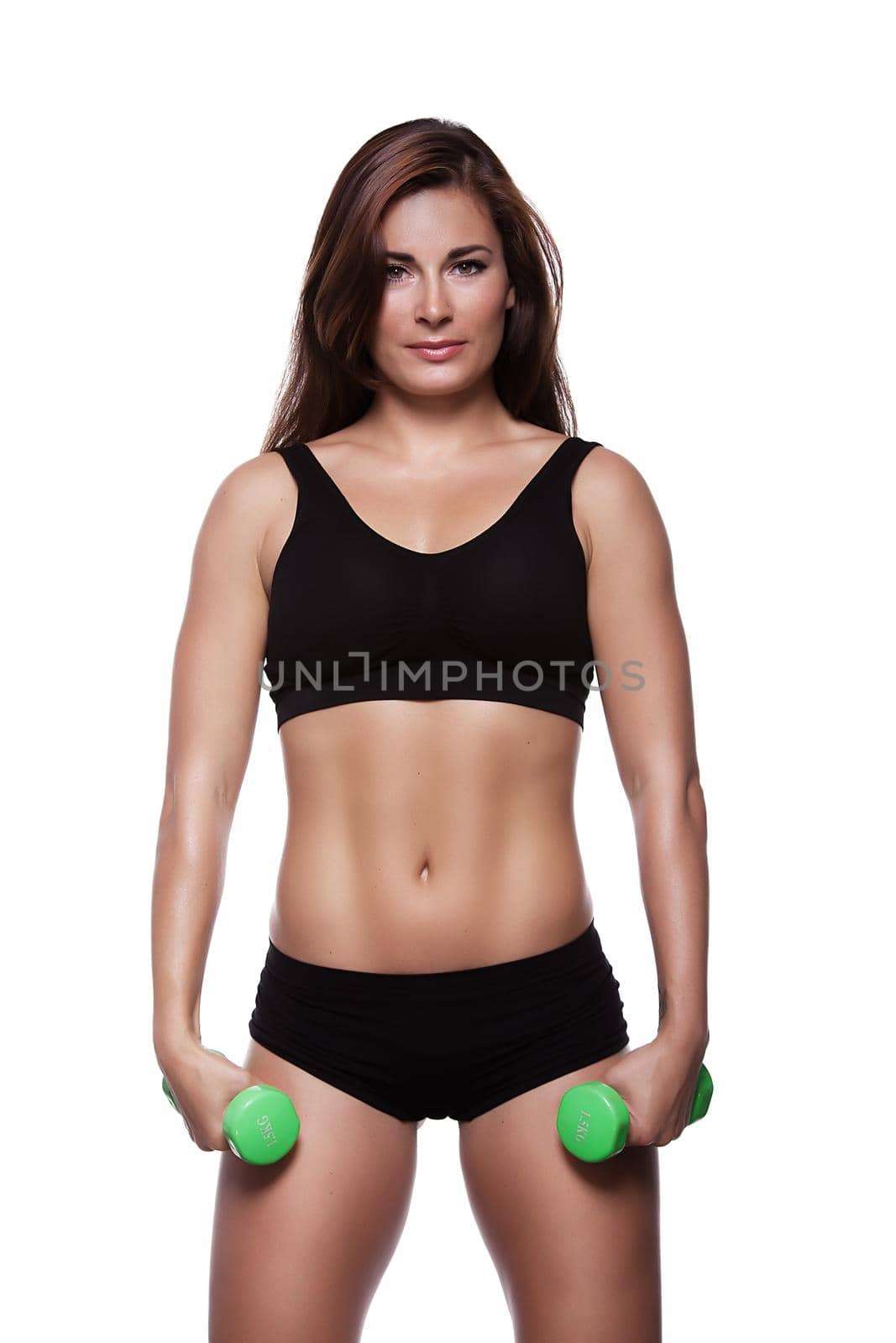Fitness sexy girl with dumbbells on a white background in black clothes