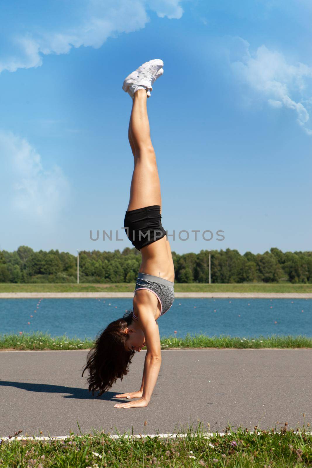 Girl doing yoga outdoors near the river