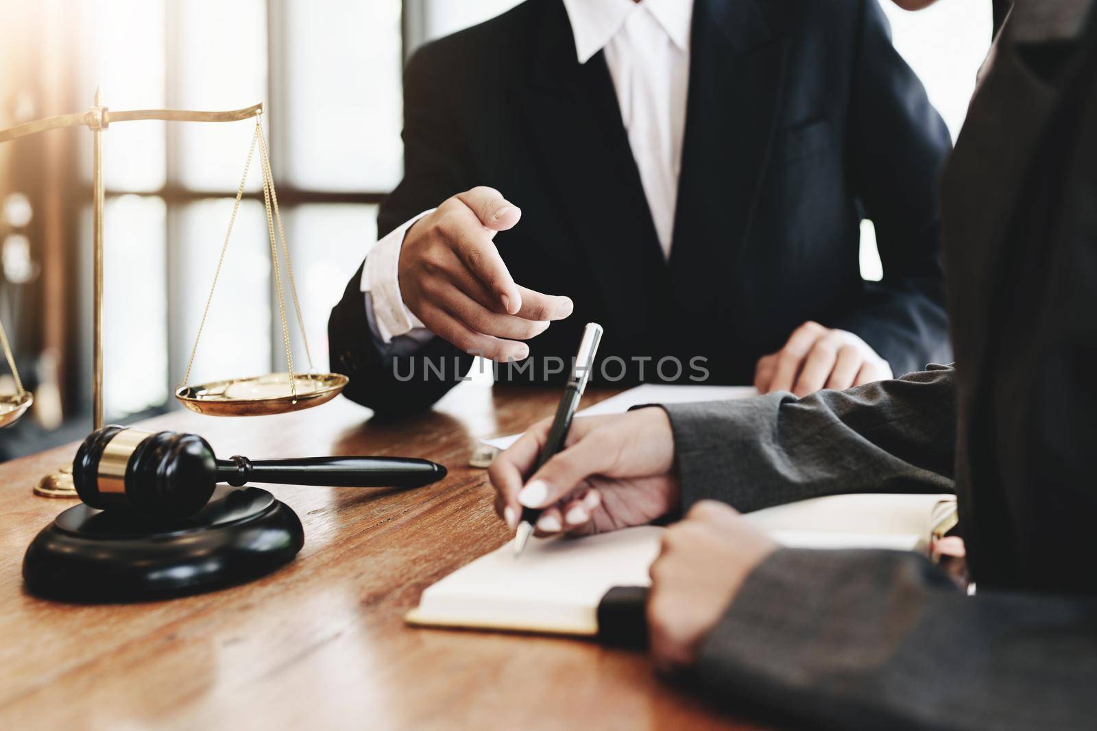 The client is consulting with a lawyer on legal matters.