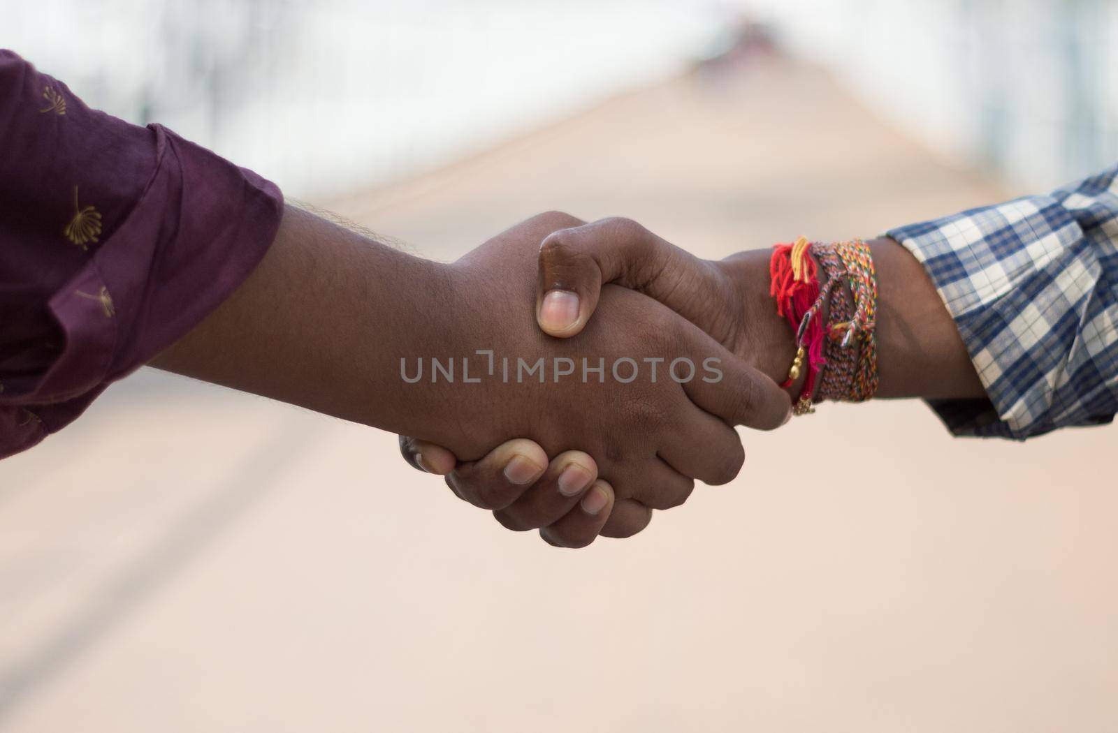 Friends shake hands. Closeup . Friendship handshake outdoor. by sudiptabhowmick