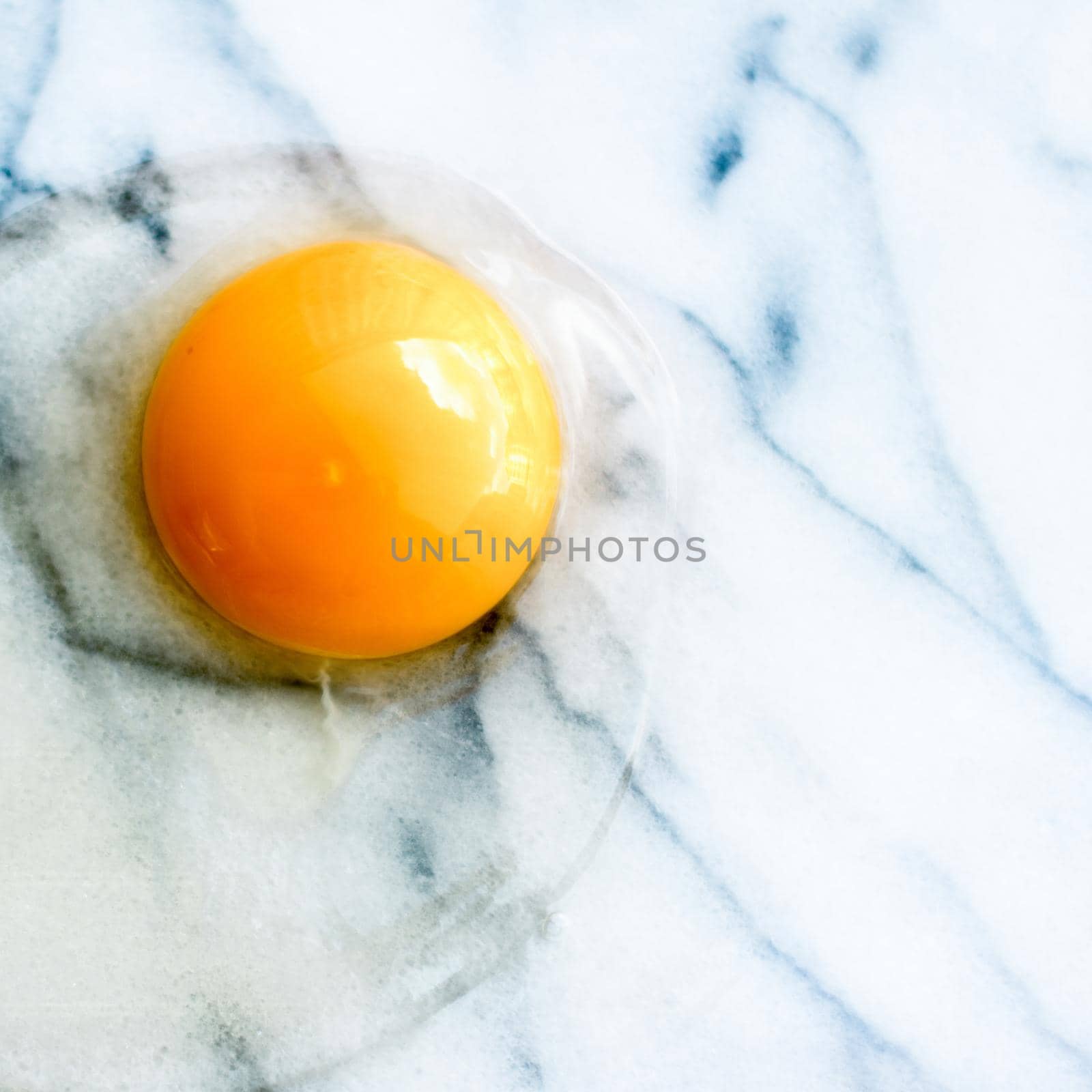 egg yolk on marble - recipe ingredients and homemade cooking styled concept