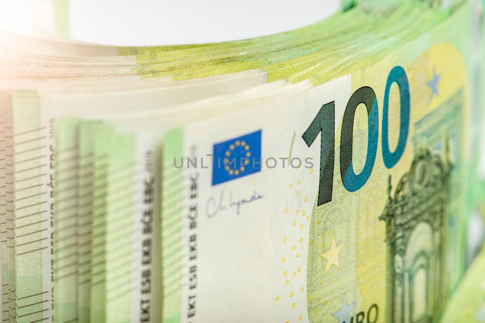 Close-up of a stack of paper bills, side view. Euro banknotes stacked on top of each other. Big pile of money