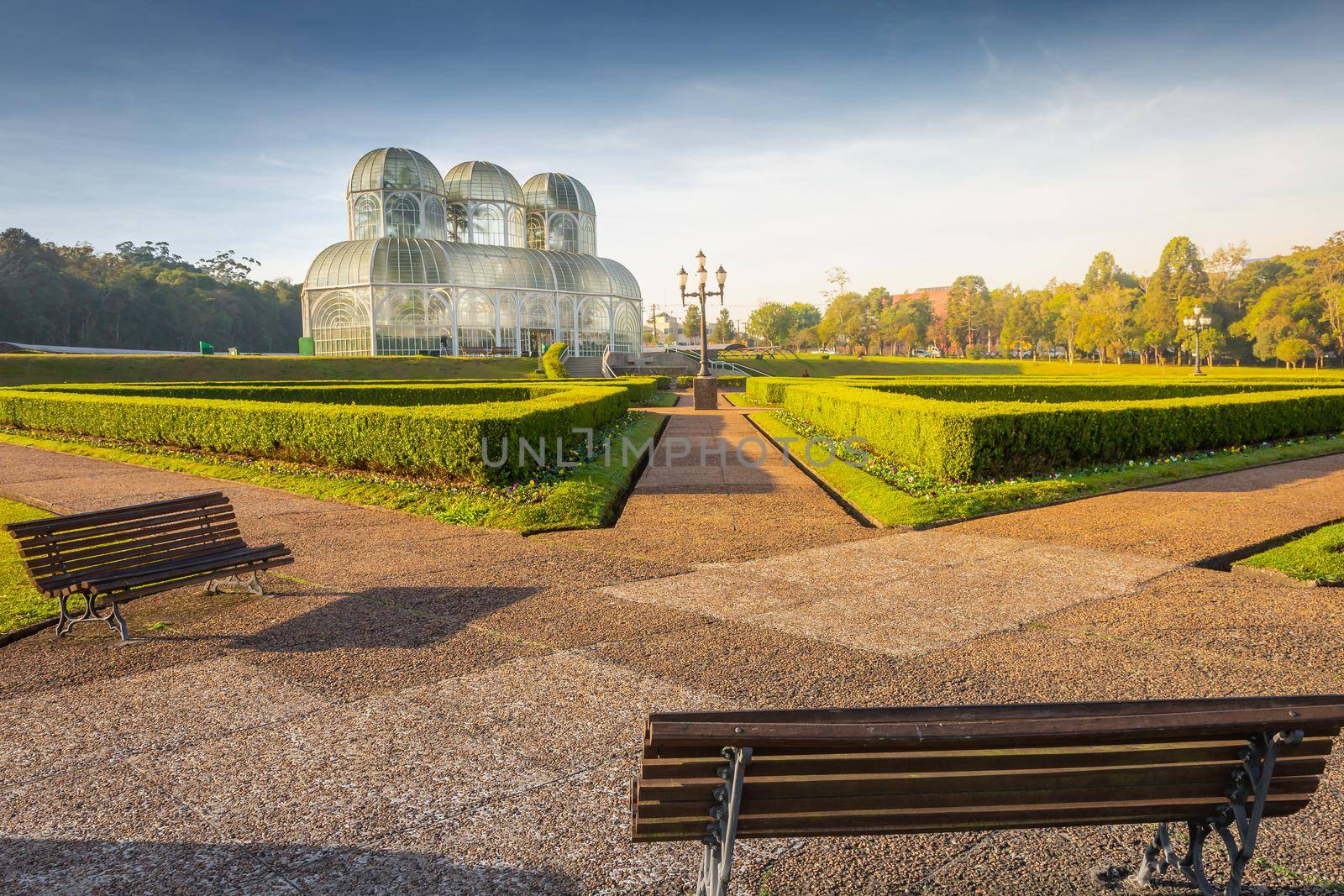 Public park around Botanical garden greenhouse in Curitiba at golden sunrise, Parana, southern Brazil