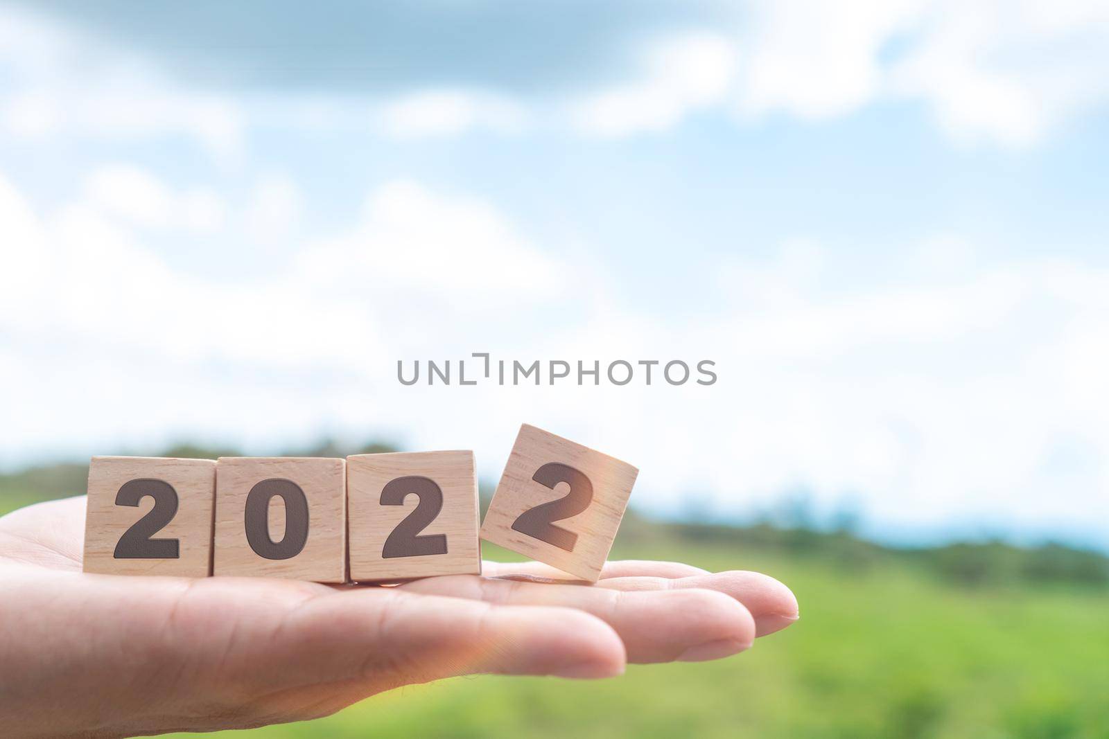 Hand hold wooden cubes 2022 background, copy space. Goal concept, action plan, strategy, new year or business vision. 
