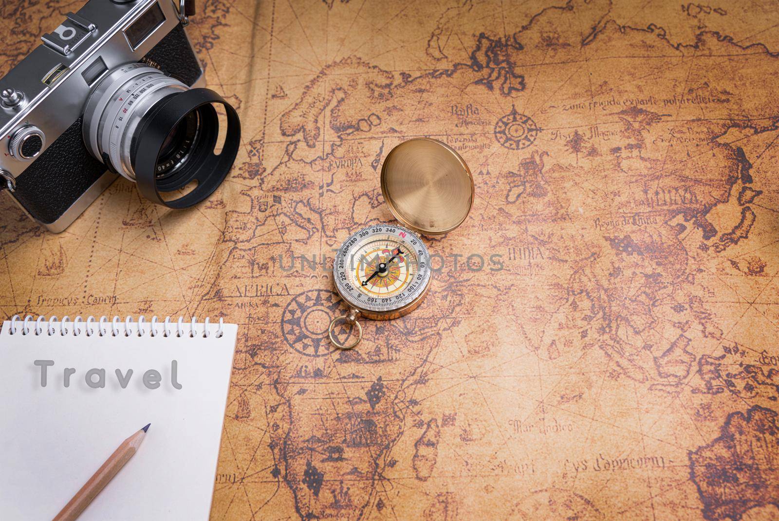 Vintage Compass and camera on map for travel planning by Buttus_casso