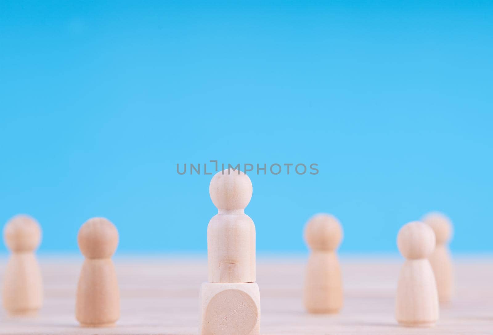 Wooden figures in photo of people.  Team and leader concept by Buttus_casso